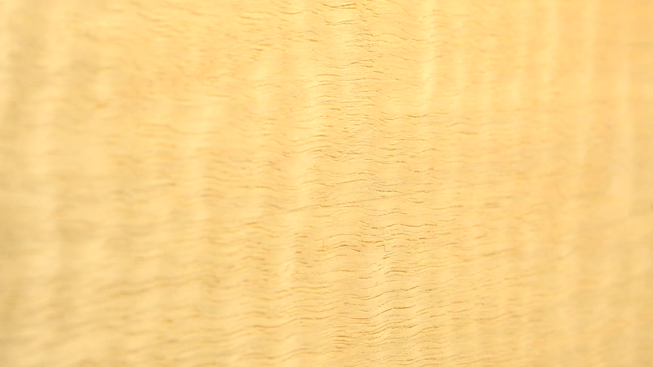 Bright honey-brown wood grain fills the frame.
