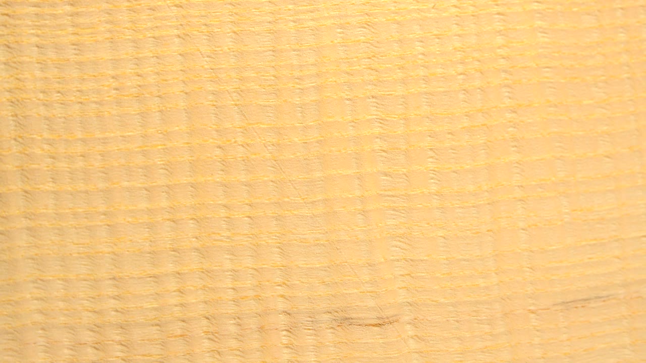 Wood surface with soft blur and faint grain lines.