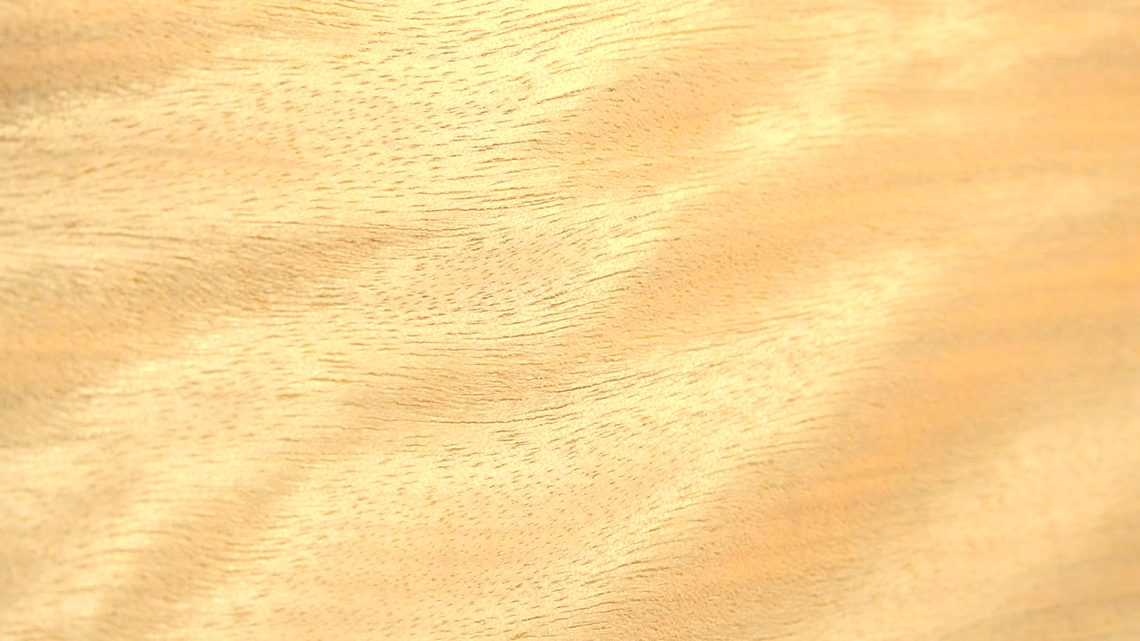 Close-up honey-colored wood grain fills the Westminster, Colorado frame at the start of the clip, with no visible people.