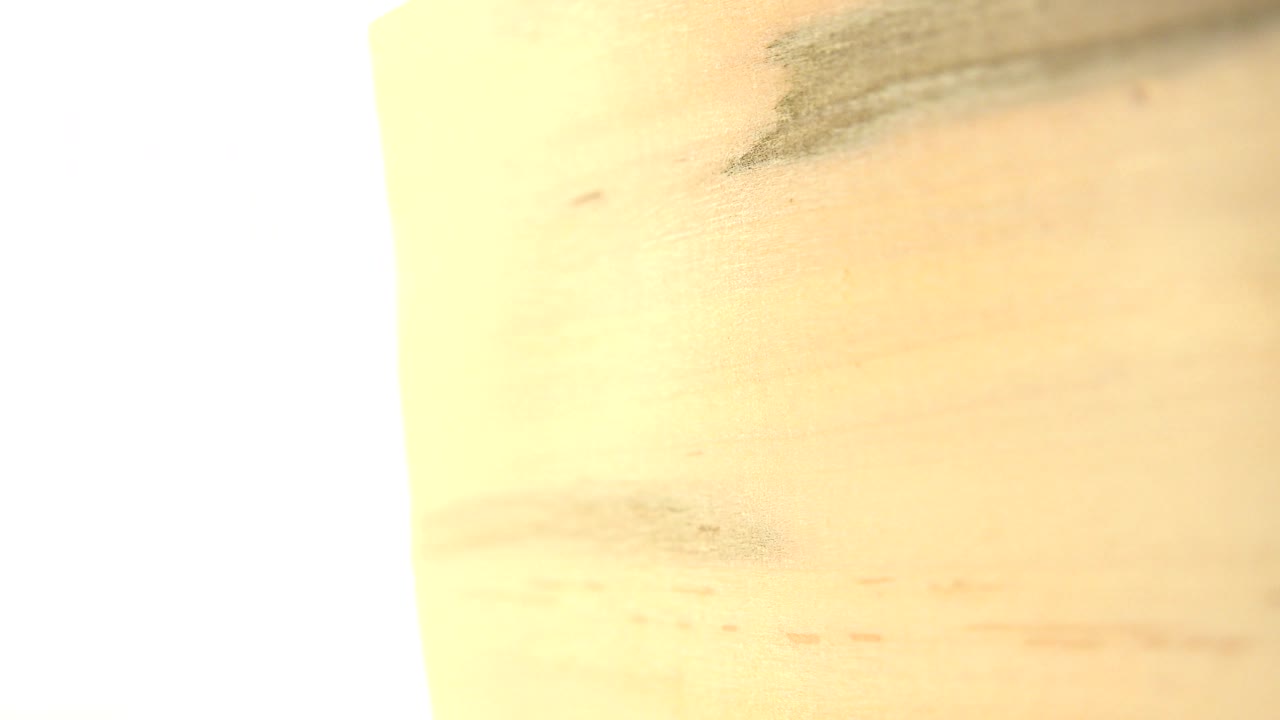 Bright overexposed edge beside blurred wood grain.