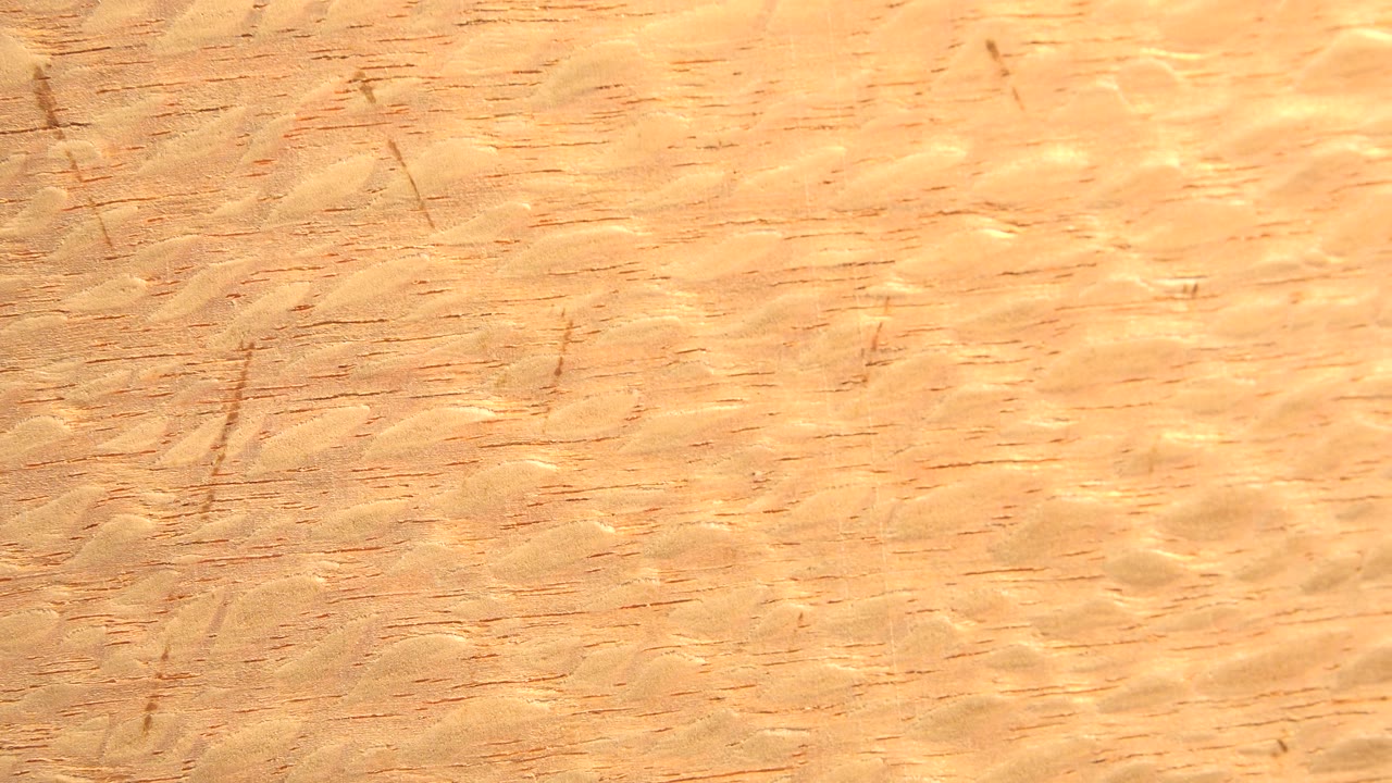 Scratched tan wood surface in close view