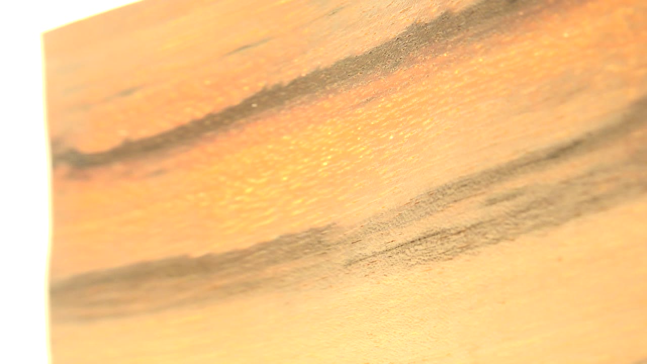 Close view of warm abstract painted texture with dark streaks