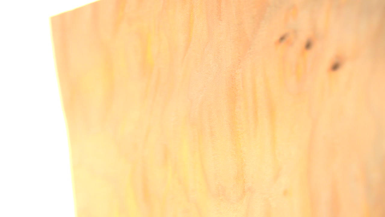 Soft macro view of a gold coin surface in Westminster, Colorado footage, with warm reflections, dark specks near the upper right, and no visible people.