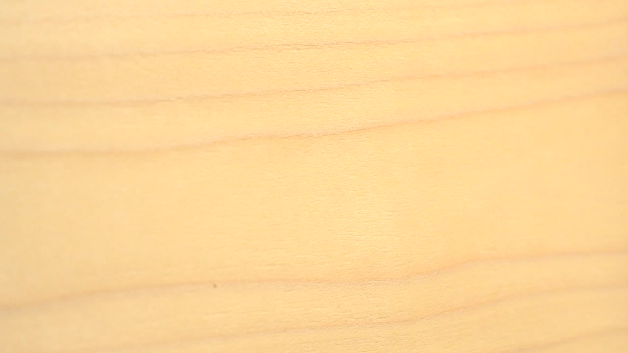 Pale wooden board grain filling the frame