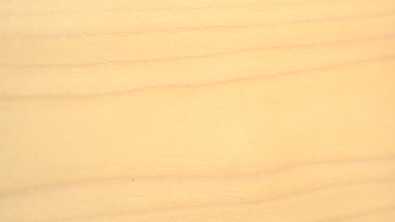 A tighter-looking section of the Westminster, Colorado board shows darker horizontal grain lines across warm pale wood, with no visible people.