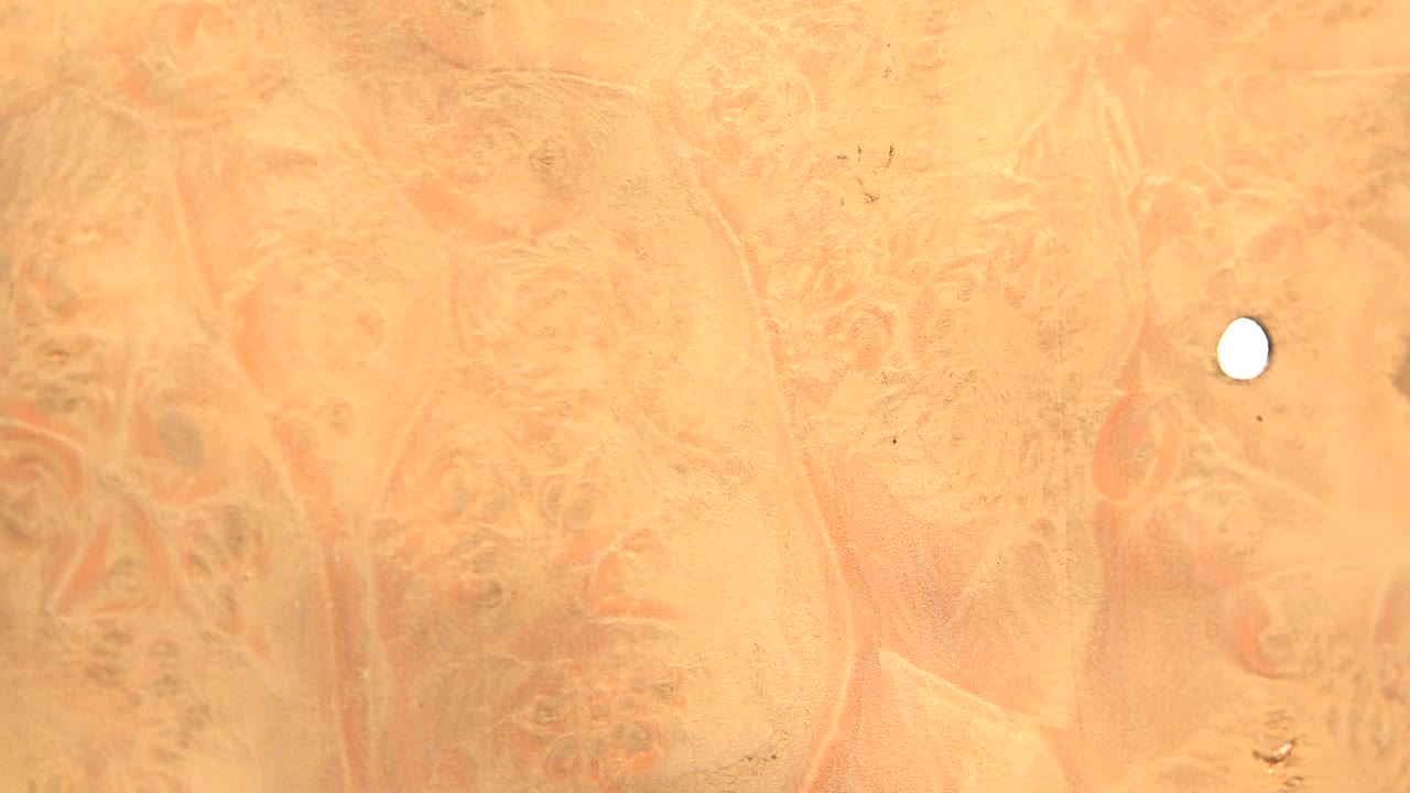 Orange marbled topographic pattern with a white point near the upper right.