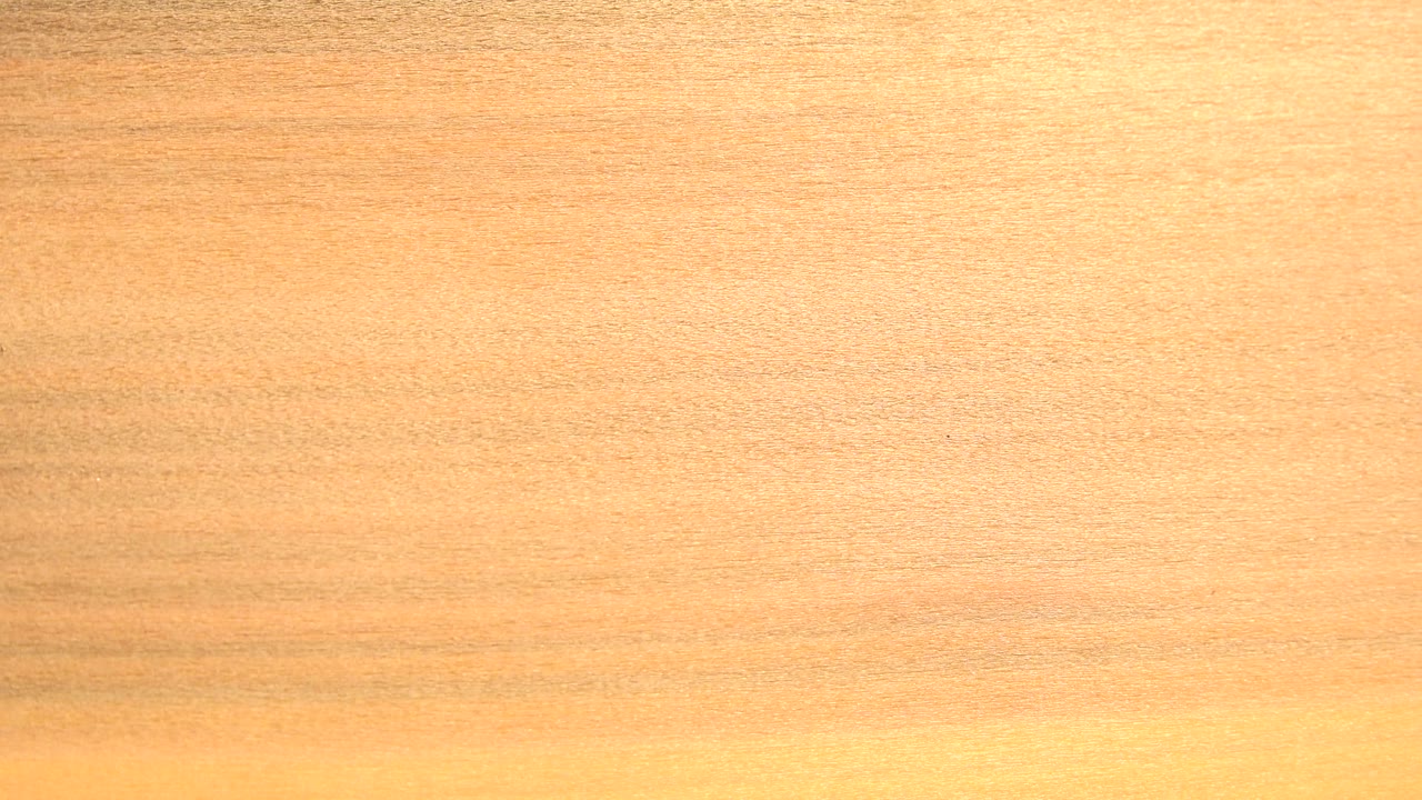 Bright overexposed yellow-white vertical area against pale wood tone.
