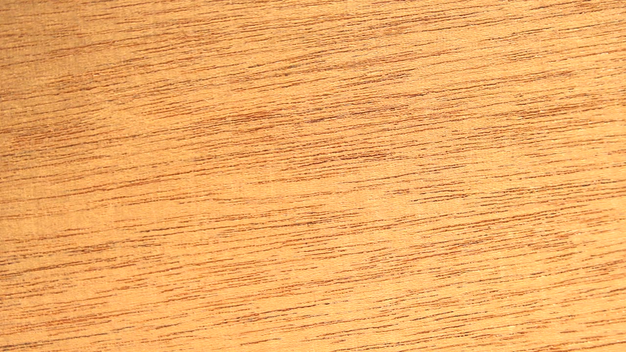 Close-up wood grain in Westminster, Colorado, filling the frame with amber tones and no visible people.