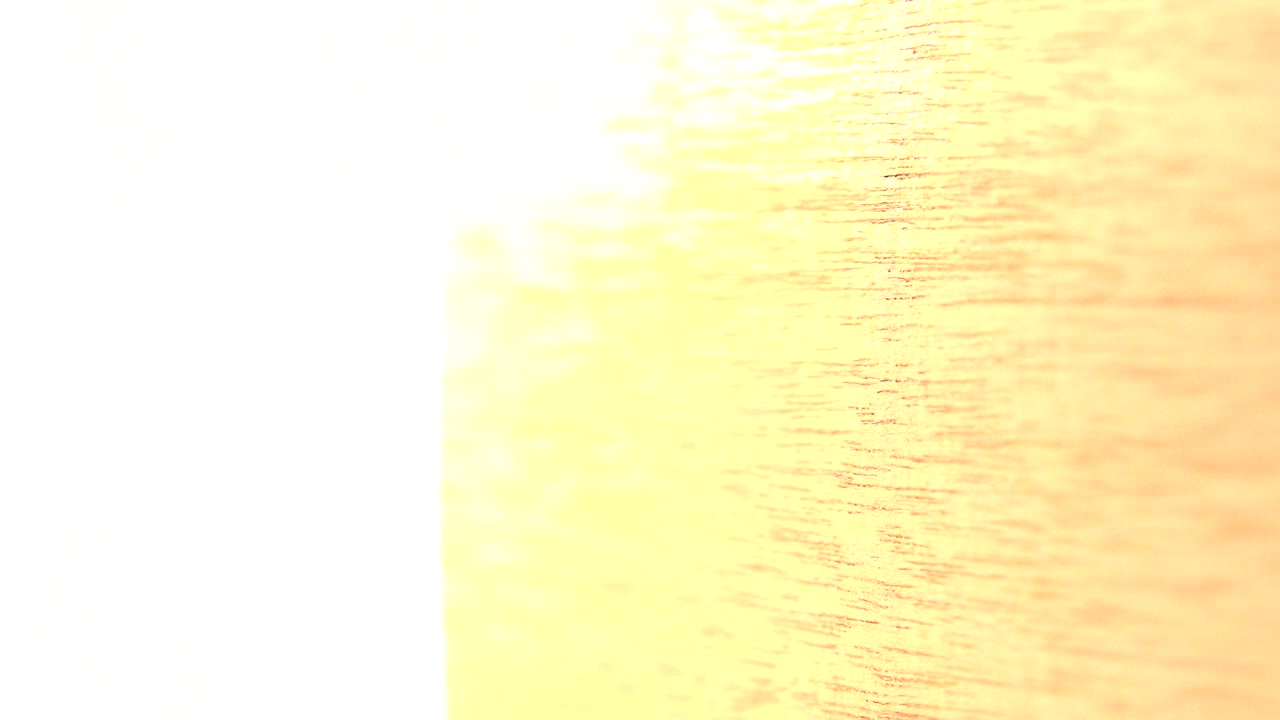 A close overexposed yellow wood surface fills the right side of the frame in Westminster, Colorado footage, with a white vertical edge and no visible people.