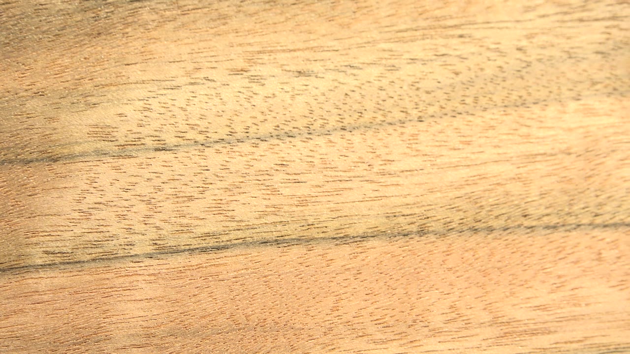 Close view of yellow-toned wood paneling in Westminster, Colorado, with dark horizontal grain lines and no visible people.