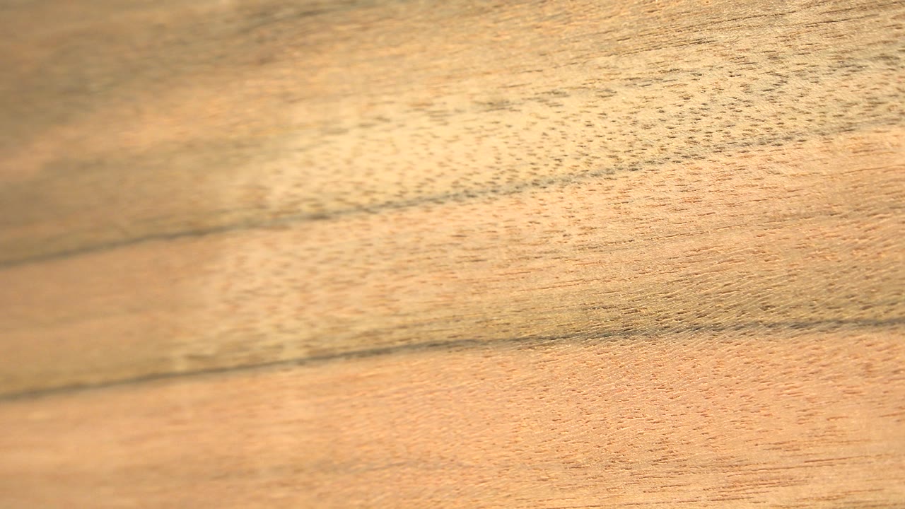 Blurred close-up of yellow wood paneling.