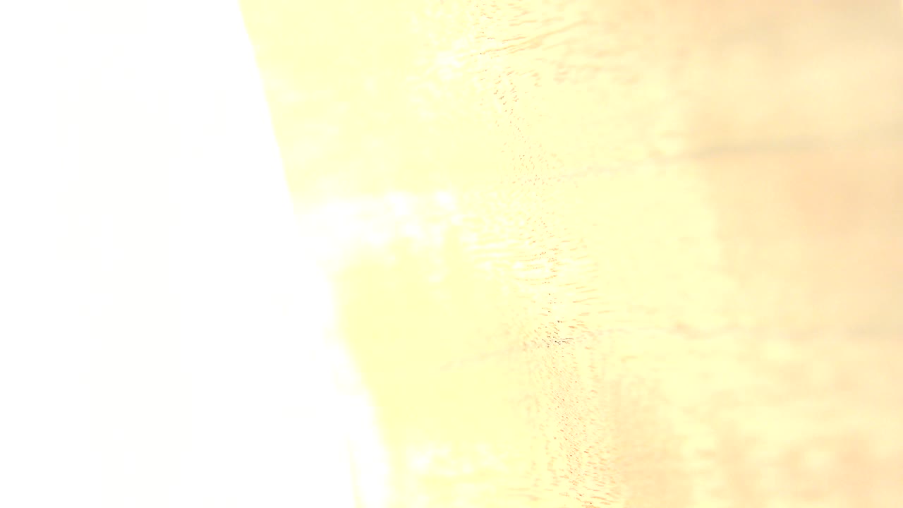 Close-up wood grain in Westminster, Colorado footage, with a bright overexposed white band on the left and no visible people.