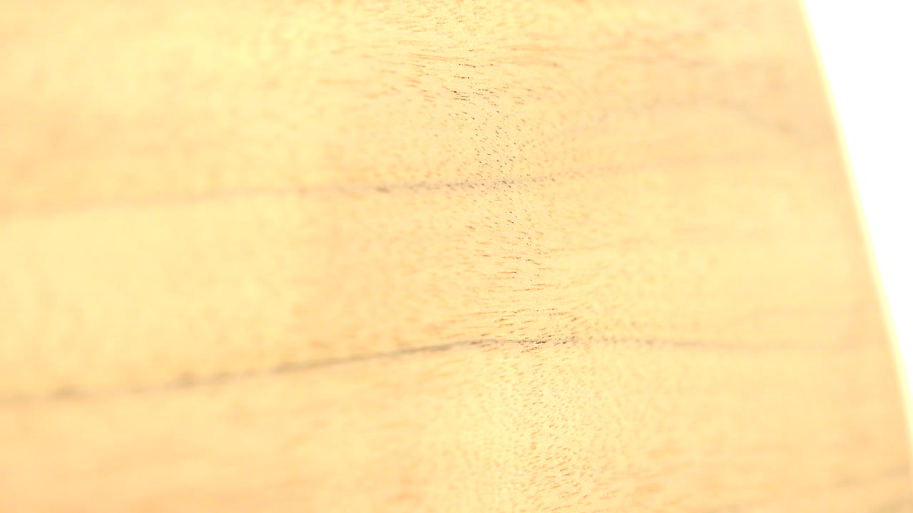Warm wood grain close-up with a bright vertical edge at right