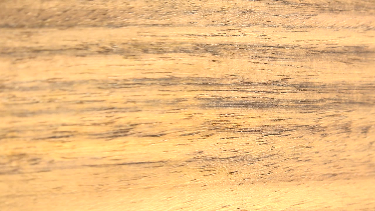 Warm close-up of the spinning rock or mineral fragment in Westminster, Colorado, with horizontal dark marks and no visible people.