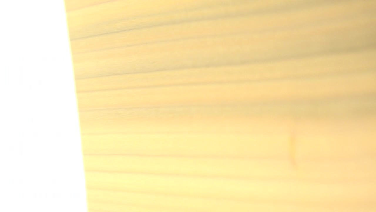 Overexposed pale area beside a rotating wood surface.