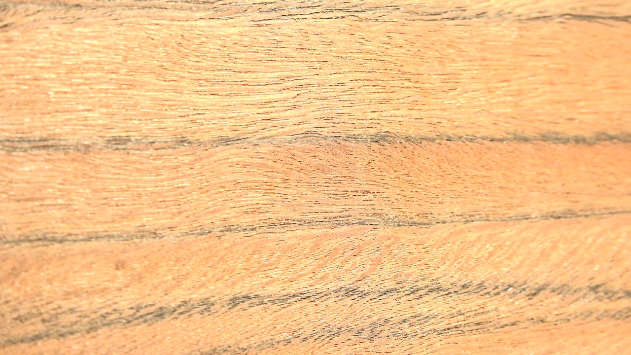 Close view of tan organic material in Westminster, Colorado, with dark horizontal grain lines across the frame and no visible people.