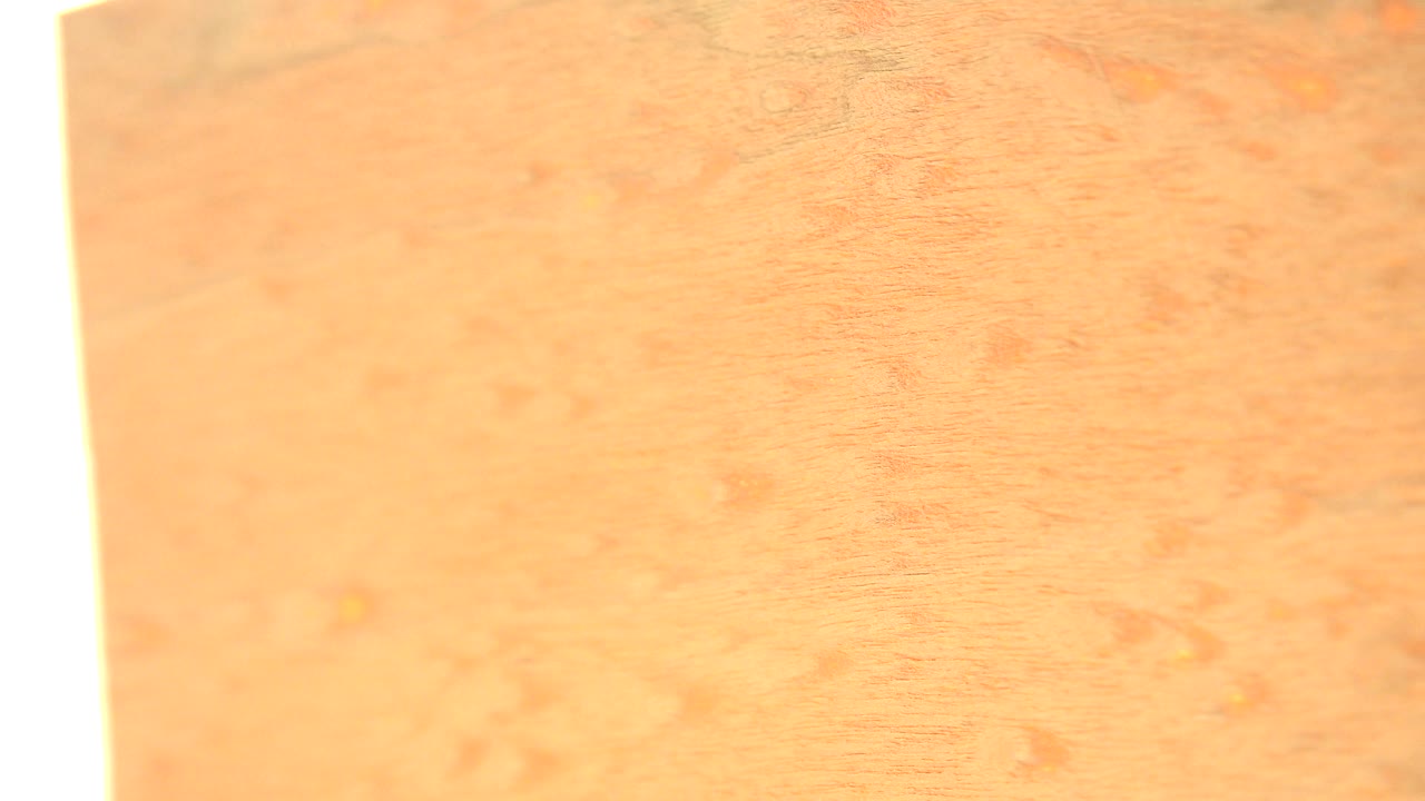 At 0:01, the wood grain has shifted slightly, with a pale vertical board edge near the left side and no visible people in the Westminster, Colorado clip.