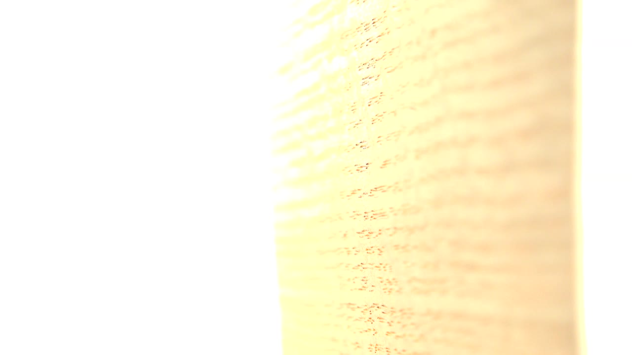 Overexposed opening frame of tan old paper texture with a bright white vertical band in Westminster, Colorado, with no visible people.