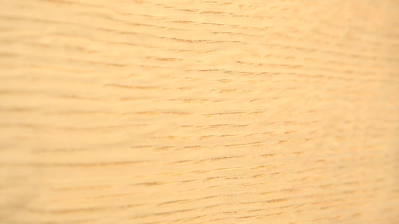 Close view of pale wood grain filling the frame.