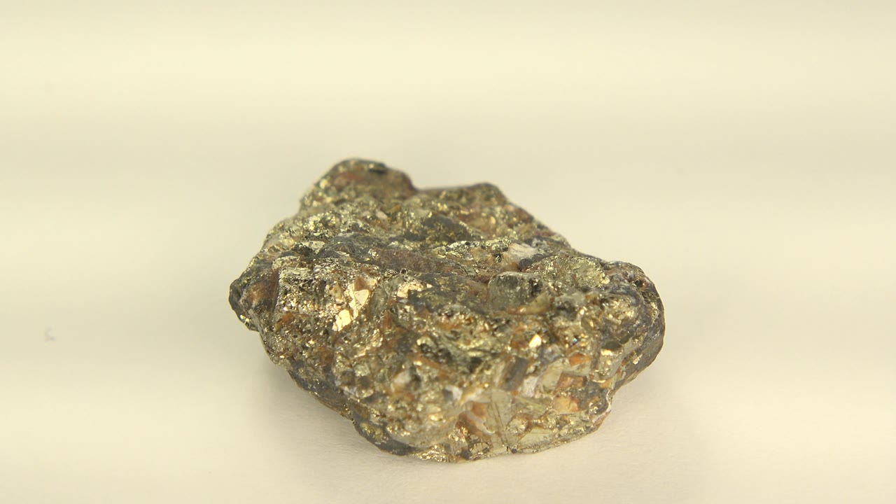 Gold-toned rock turned to show a lower side profile.