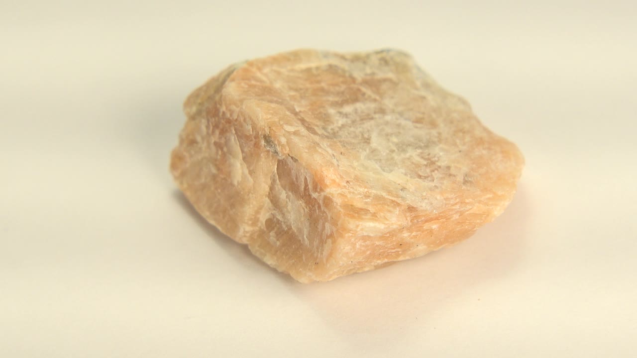 Low angled sandstone rock with orange and gray texture.