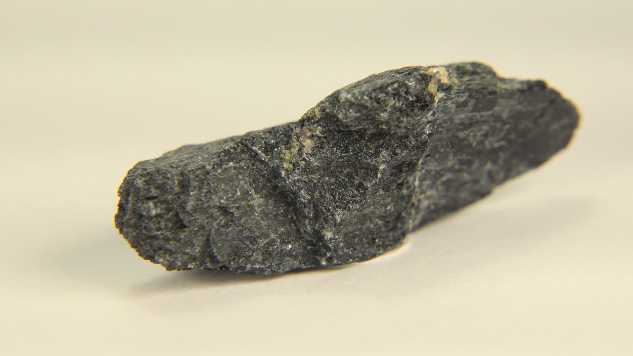 Elongated dark stone angled across the frame