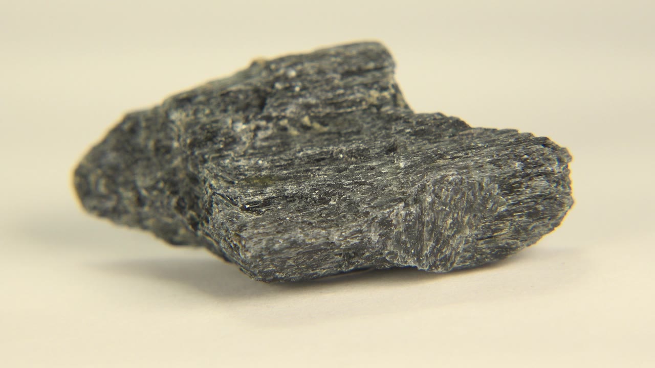 Small jagged stone angled across a pale surface