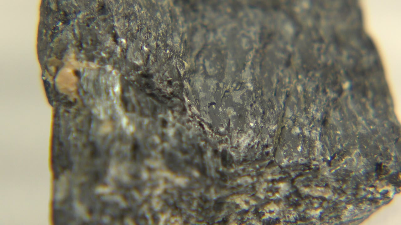 Close-up of the rock edge with dark mineral texture.