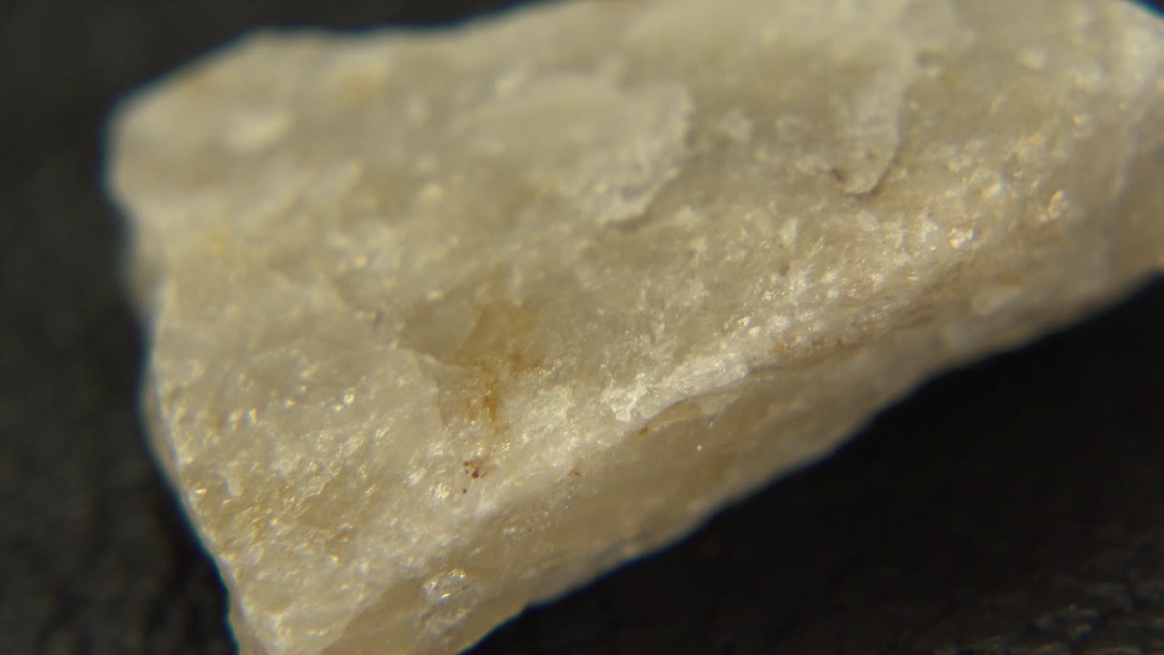 Yellow mineral shard angled across a dark background