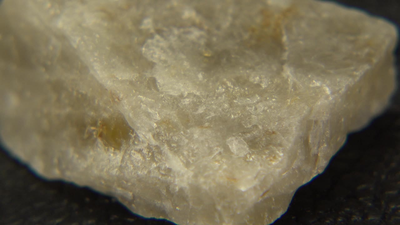 Angular pale stone with light catching its surface.