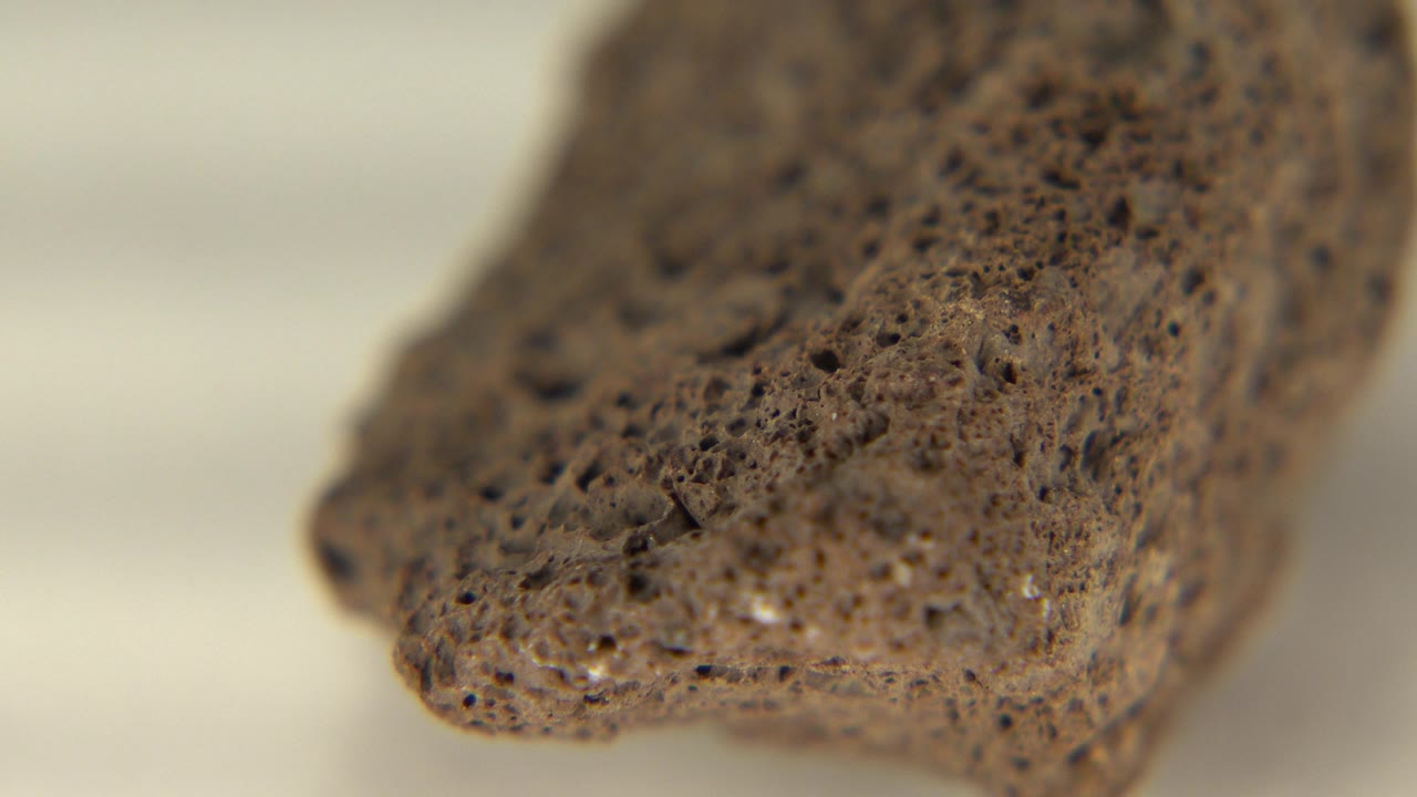 Porous stone angled toward the camera with soft focus.