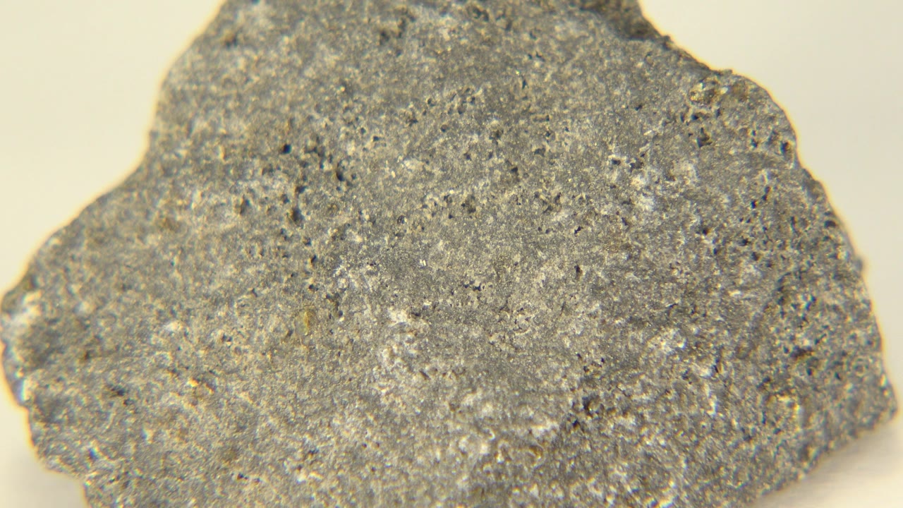 Close view of the speckled gray mineral rock in Westminster, Colorado, with a slightly shifted face and no visible people.