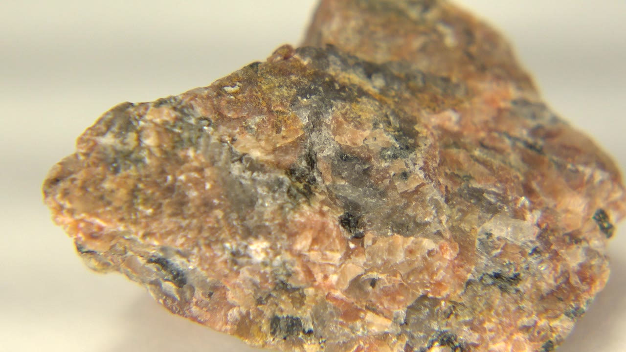 The rock remains large in frame as its tan, rust, and gray textures face the camera on the rotating table in Westminster, Colorado, with no visible people.