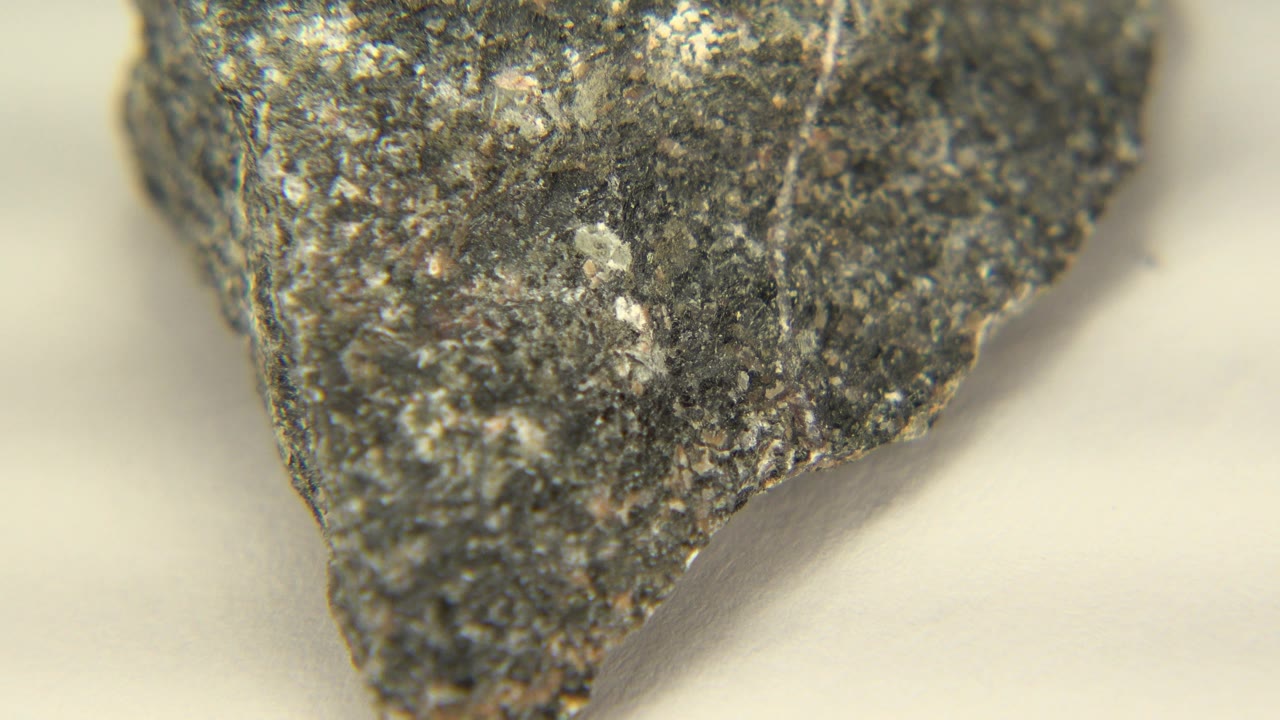 Gray rock face with rough texture and pale background.
