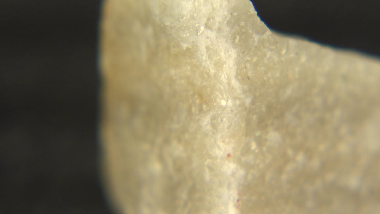 Close view of a pale rock point with soft shine.
