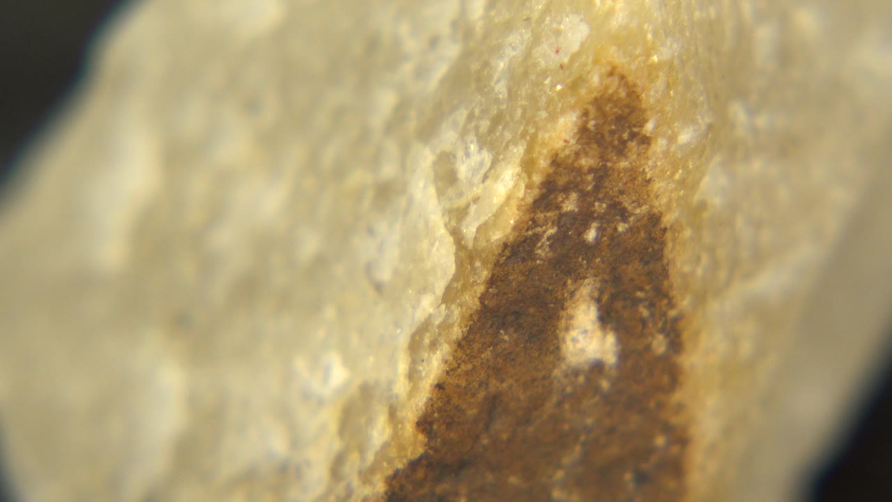 Close rock texture with brown stained area shifted to the right.
