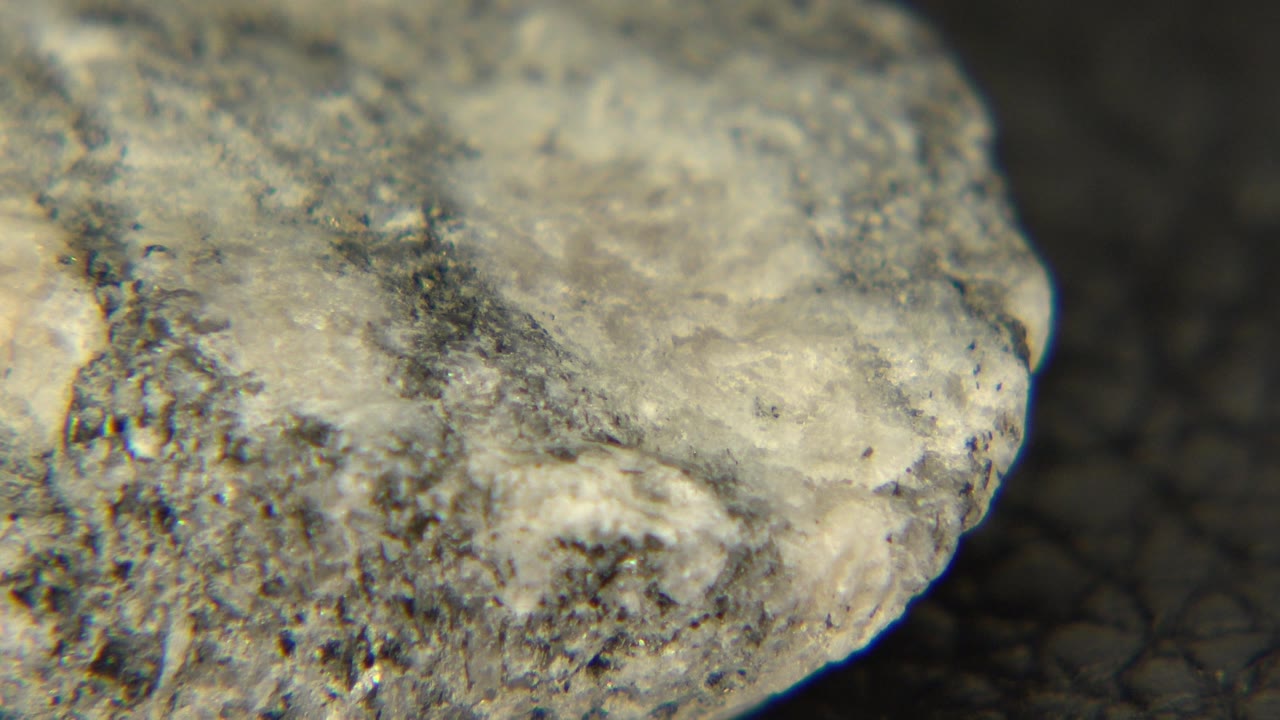 Rock corner with white face and dark floor behind