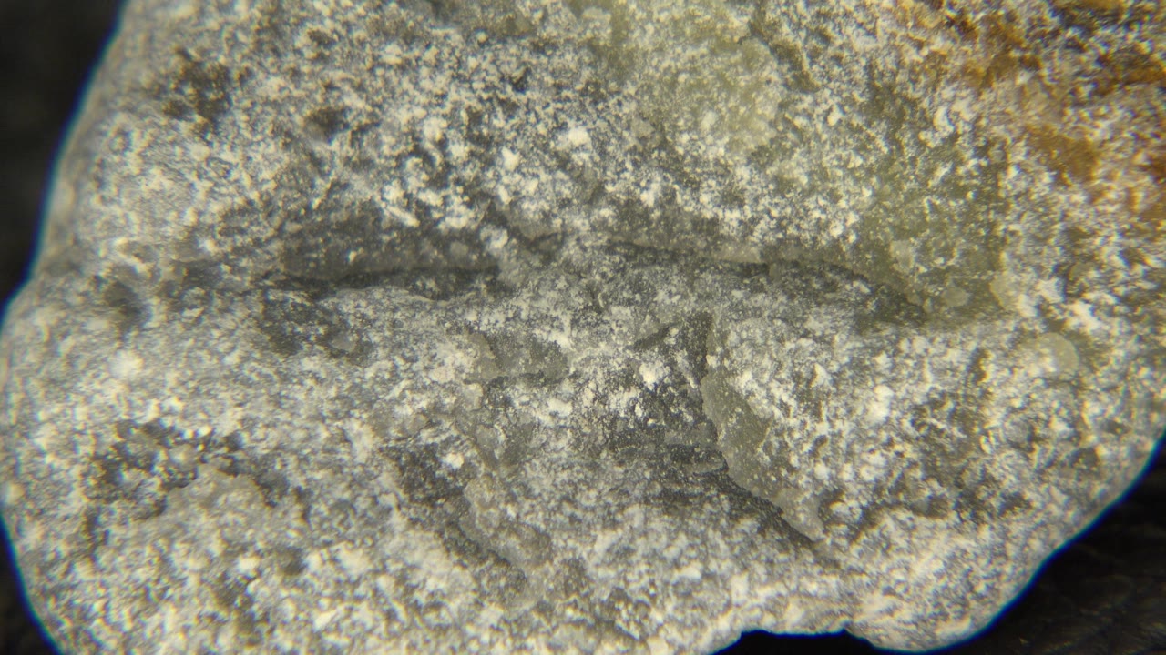 A pale gray and tan rough stone fills the first frame of the Westminster, Colorado clip, with granular texture and no visible people.