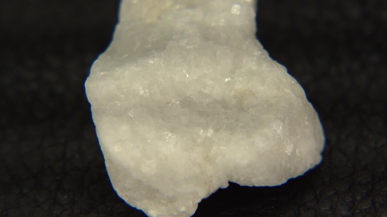 White crystal rock turned slightly on black background
