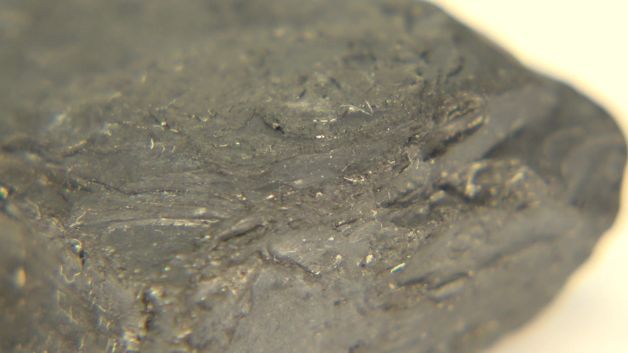 Close view of a grey rock corner with rough texture.