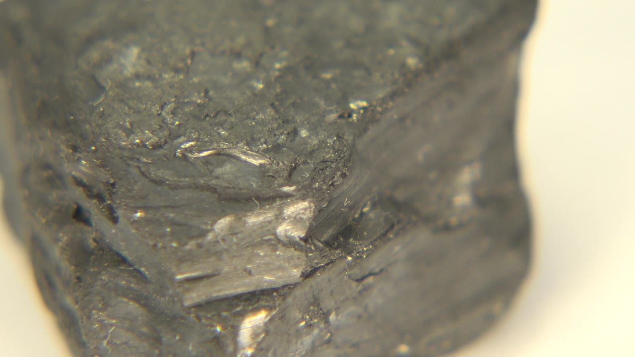The gray rock appears at a slightly different angle on the white spinning surface in Westminster, Colorado, with no visible people.