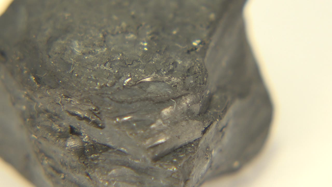 Gray rock face with rough pitted texture