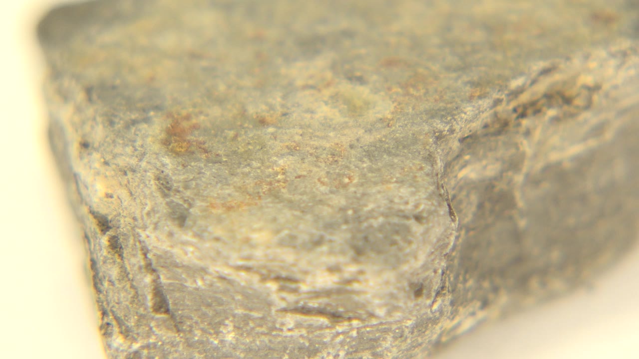 The second frame holds on the same Westminster, Colorado rock, showing a flatter upper surface, tan specks, blurred edges, and no visible people.