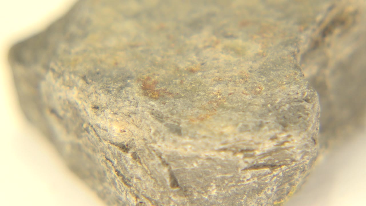 Angled close-up of a rough gray stone edge.