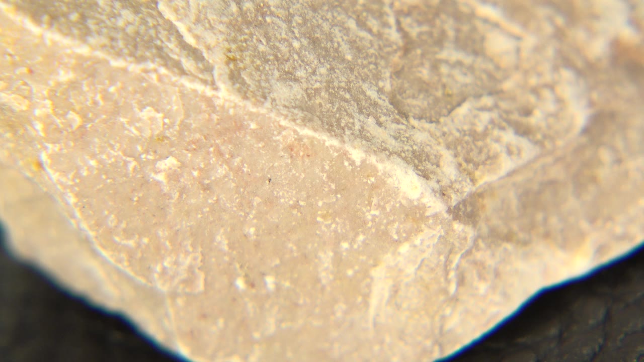 Rough yellow stone corner fills the frame with soft focus around the edges.