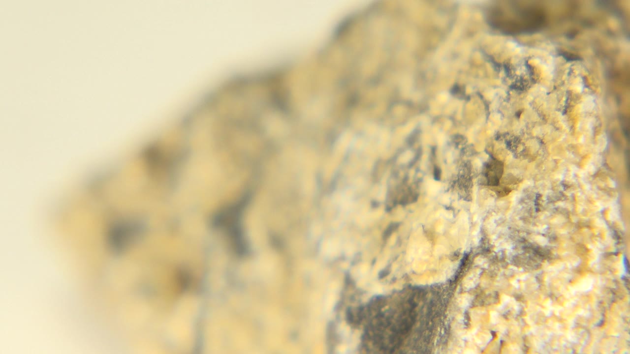 Rounded rock ridge in warm light with blurred background.