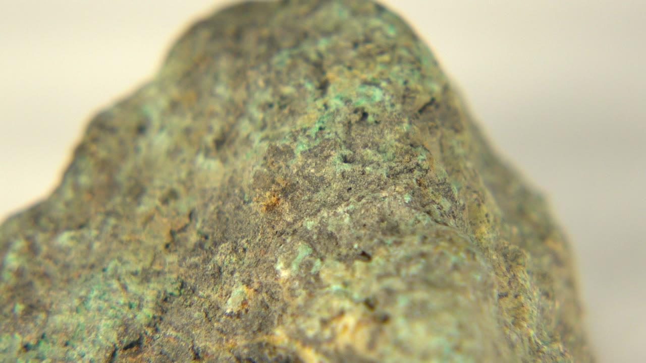 The second Westminster, Colorado frame keeps the rock large in view, emphasizing gray grit, green flecks, and shallow focus, with no visible people.