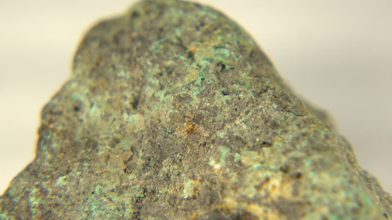 Close view of the rock with green and tan speckles.