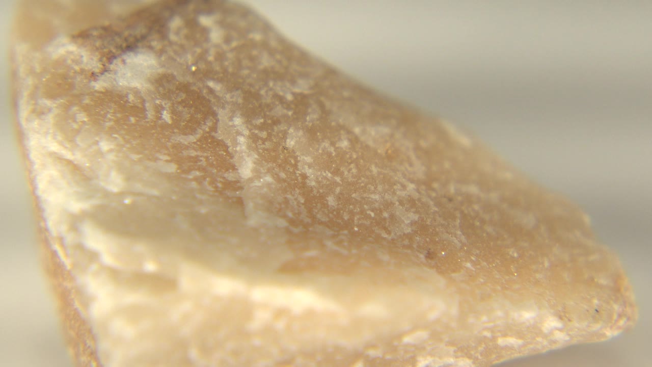 Pinkish stone point with pale crystalline edge.
