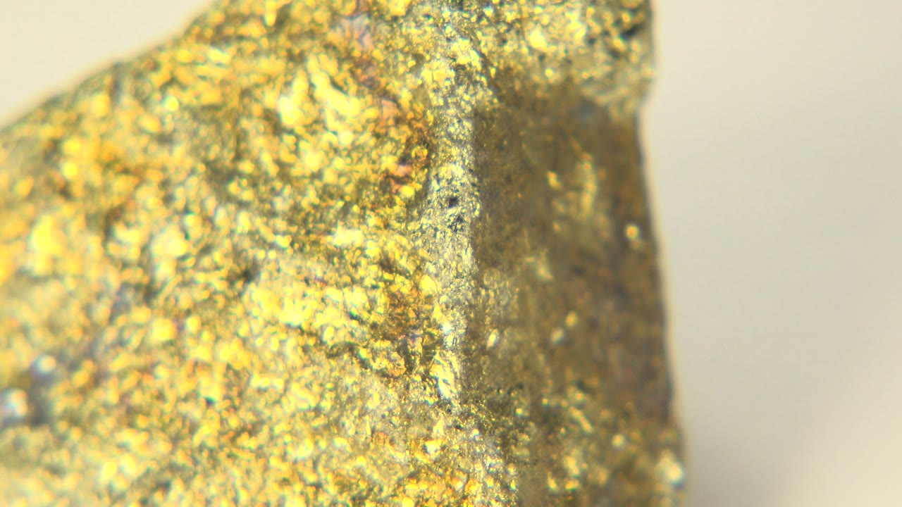 The gold-colored stone remains tightly framed in Westminster, Colorado, with more speckled texture visible across the front and no visible people.